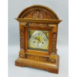Walnut cased mantle clock with a silver dial and Arabic numerals, 40cm high