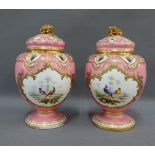 Pair of 19th century pink glazed porcelain lidded vases, the covers pierced and with acorn