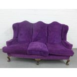 Queen Anne style purple velvet upholstered sofa with triple hump back, loose cushions and cabriole