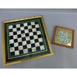 Two coloured glass chess boards, one in a giltwood frame, largest 50 x 50cm (2)