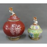Two Herend Hungarian porcelain jars with covers and dolphin finials and brass footrim, tallest