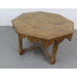 Oak table the octagonal top with carved floral pattern, on ring turned legs with cross stretcher, 52