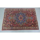 Persian rug with red field and central flowerhead medallion, 206 x 138cm