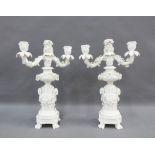 Pair of Meissen white glazed candelabra with twin branches and floral encrusted overall, on a column