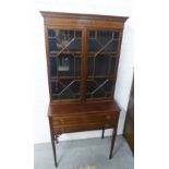 Mahognay bookcase cabinet, the cornice top with a dentil frieze above a pair of glazed doors with