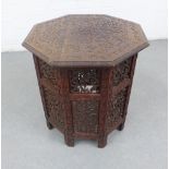 Moorish style side table with octagonal carved top and pierced folding base, 57 x 53cm