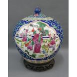Chinoiserie pottery jar and cover painted with figures to a blue foliate ground, complete with a