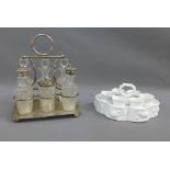 Epns and glass cruet stand with bottle and jars and a white glazed egg cup stand with set of six egg