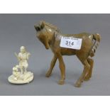 Early 20th century Japanese ivory okimono, 7cm high and a carved wooden horse, 12cm high (2)