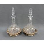 A pair of globe and shaft dimpled glass decanters with stoppers and a pair of silver plated wine