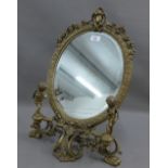 Brass mirror with cherubs and oval bevelled plate, 58cm high