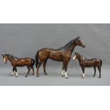 Large Beswick brown glazed horse and two smaller Beswick horses, tallest 31cm high (3)