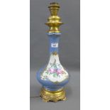 French porcelain tale lamp base with gilt base and collar, painted with flowers to a pale blue