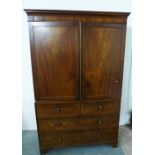 Georgian mahogany linen press with cornice top over a pair of cupboard doors with pull out slide