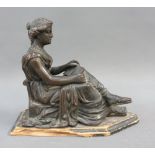 Bronze figure of a female, modelled seating and reading, on a wooden plinth, 18cm long