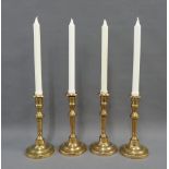 Set of four brass knop stemmed candlesticks, with candles (4)