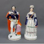 Queen Victoria and Prince Albert Staffordshire figures, each modelled standing upon an oval gilt