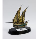 Silver sailing boat dhow, stamped 925, on an ebonised oval stand, 9cm high