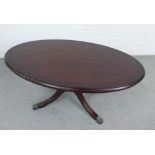 Modern mahogany coffee table with oval top and quadruple legs, 48 x 100cm