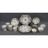 A 19th century English porcelain teaset with handpainted flowers and gilt rims, comprising twelve