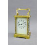 French brass and glass panelled carriage clock, the enamel dial with Arabic numerals flanked by