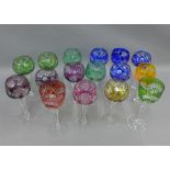 Set of fourteen Bohemian wine glasses with harlequin coloured cut glass bowls and two others of