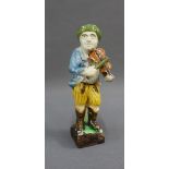 Early 19th century Prattware figure of a fiddler, on square wooden base, 17cm high