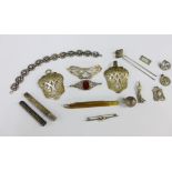Early 20th century silver and white metal items to include a buckle, hair slide, brooches, bracelet,