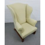 Wing back armchair of large proportions, upholstered in cream fabric, 125 x 101cm