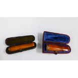 Two 9ct gold mounted amber cheroot's, with cases, (2)