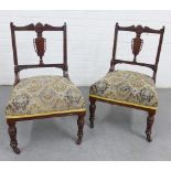 Pair of mahogany chairs with urn splat backs, upholstered seats and ring turned legs, with castors