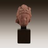 An Indian mottled pink sandstone head of a bodhisattva, 9th-11th century or earlier