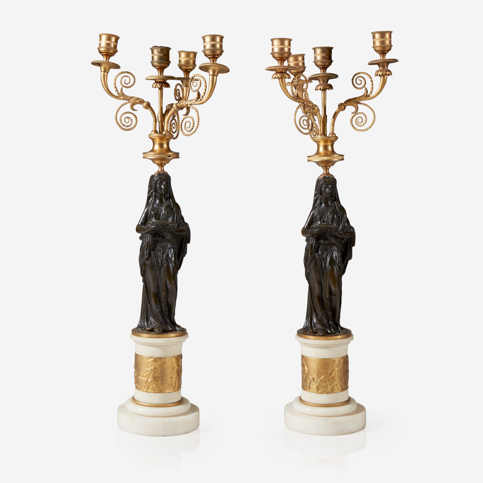 A pair of Empire gilt and patinated bronze and white marble figural four-light candelabra, First qua