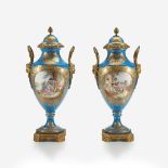 A pair of Sèvres style bleu céleste gilt-metal mounted parcel-gilt and hand-painted covered vases, L