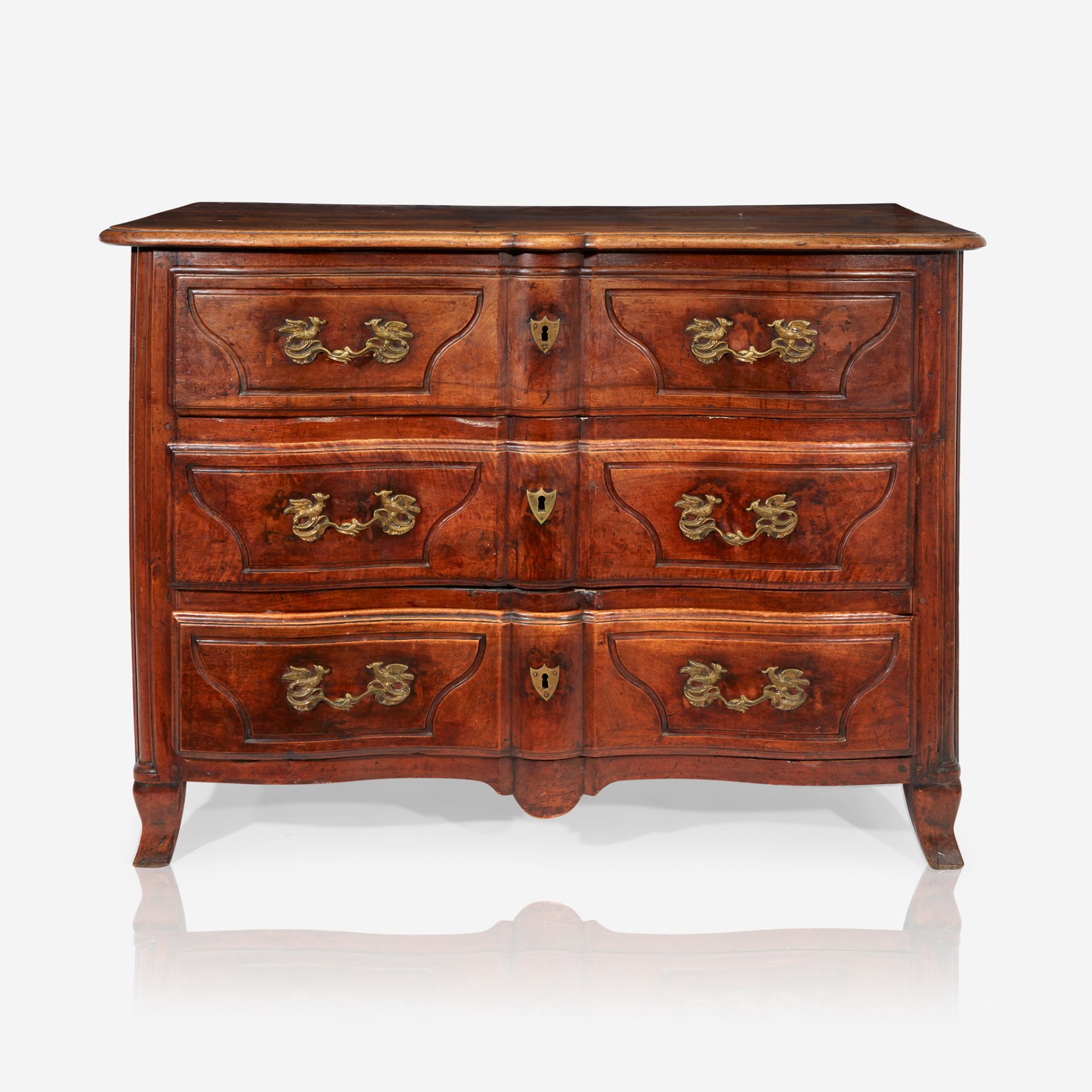 A Régence walnut commode with unusual bird-form ormolu mounts, Second quarter 18th century