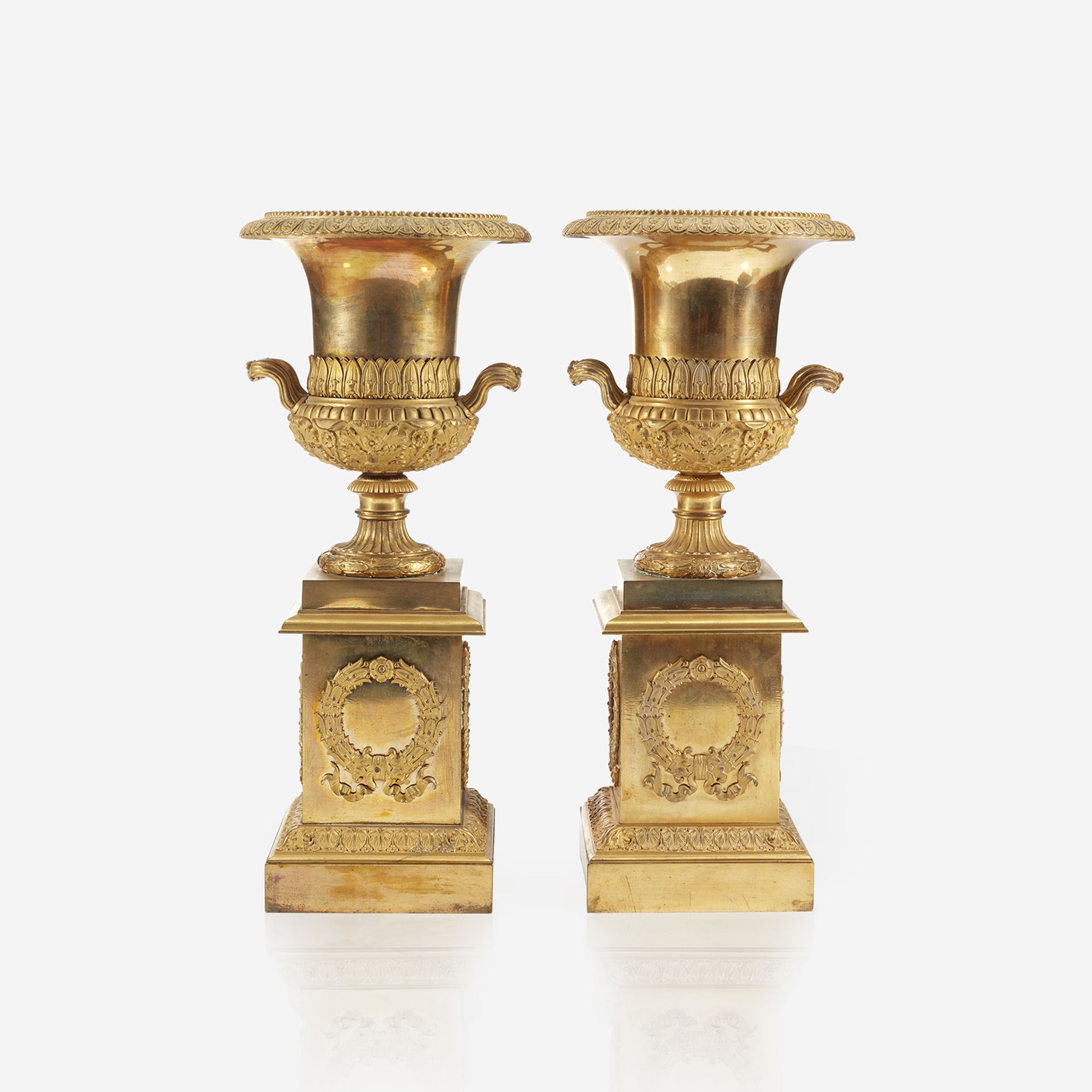 A pair of Charles X ormolu campana urns on pedestals in the manner of Pierre-Philippe Thomire (Frenc