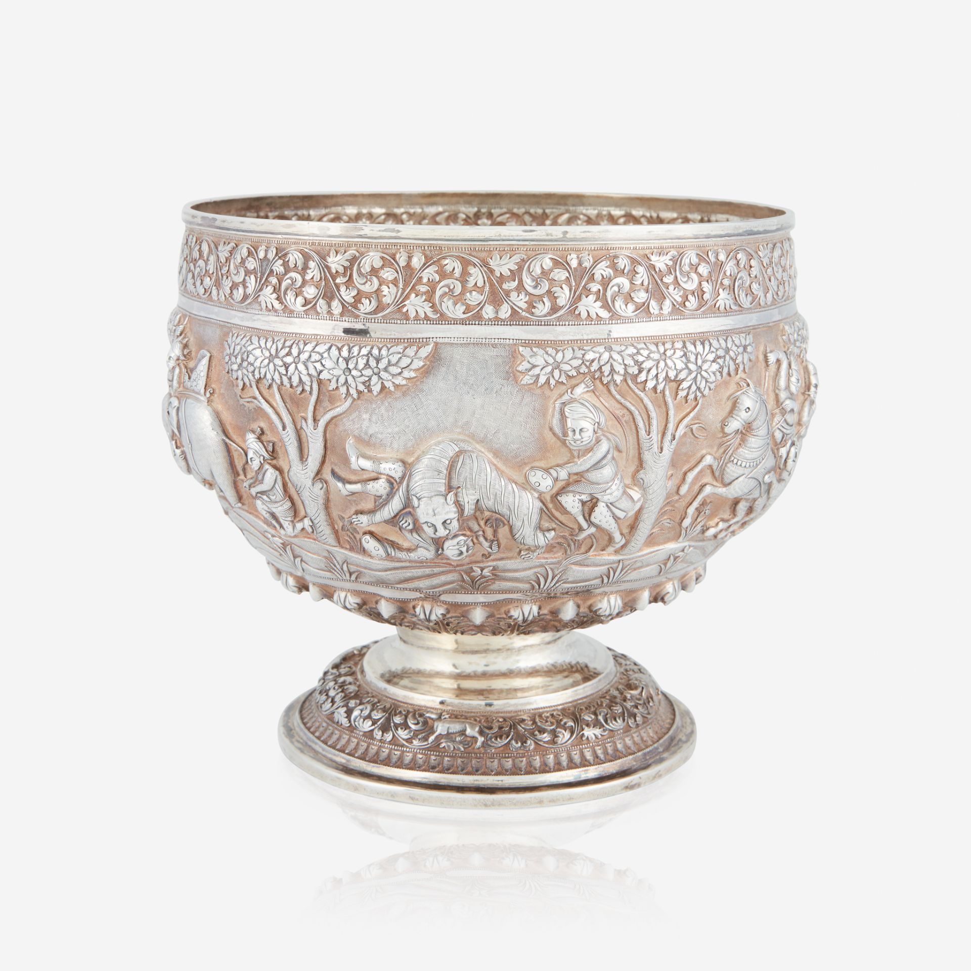 A Southeast Asian repoussé silver bowl decorated with hunt scenes, apparently unmarked