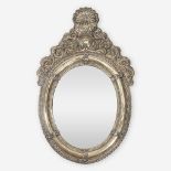 A Central/South American repoussé silvered metal mirror, Late 19th/early 20th century