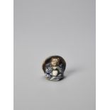 WAHEI: A RARE PORCELAIN NETSUKE OF A TANUKI