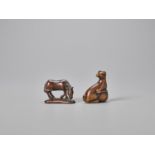 TWO WOOD NETSUKE OF A HORSE AND A DOG WITH BALL
