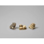 THREE IVORY NETSUKE OF SHISHI