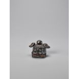 A MECHANICAL KUROGAKI WOOD MASK NETSUKE OF A SHISHI