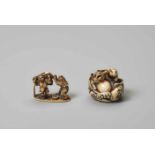 TWO IVORY NETSUKE OF A TANUKI WITH RABBIT