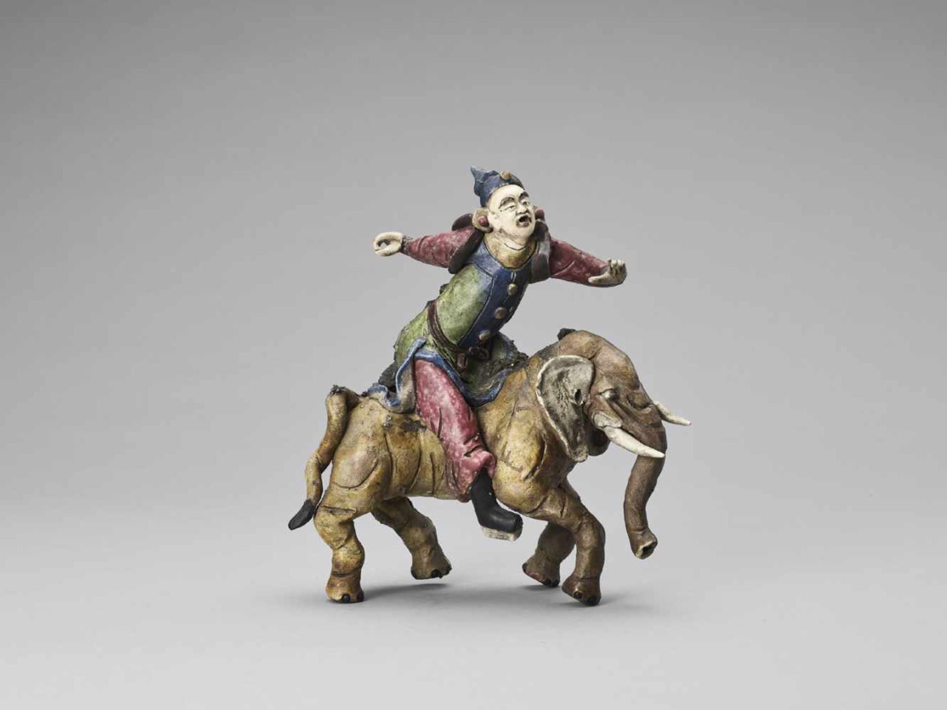 A GLAZED TERRACOTTA FIGURE OF A DIGNITARY RIDING AN ELEPHANT, MID-QING