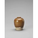 AN OCHRE BROWN-GLAZED POTTERY JAR, TANG