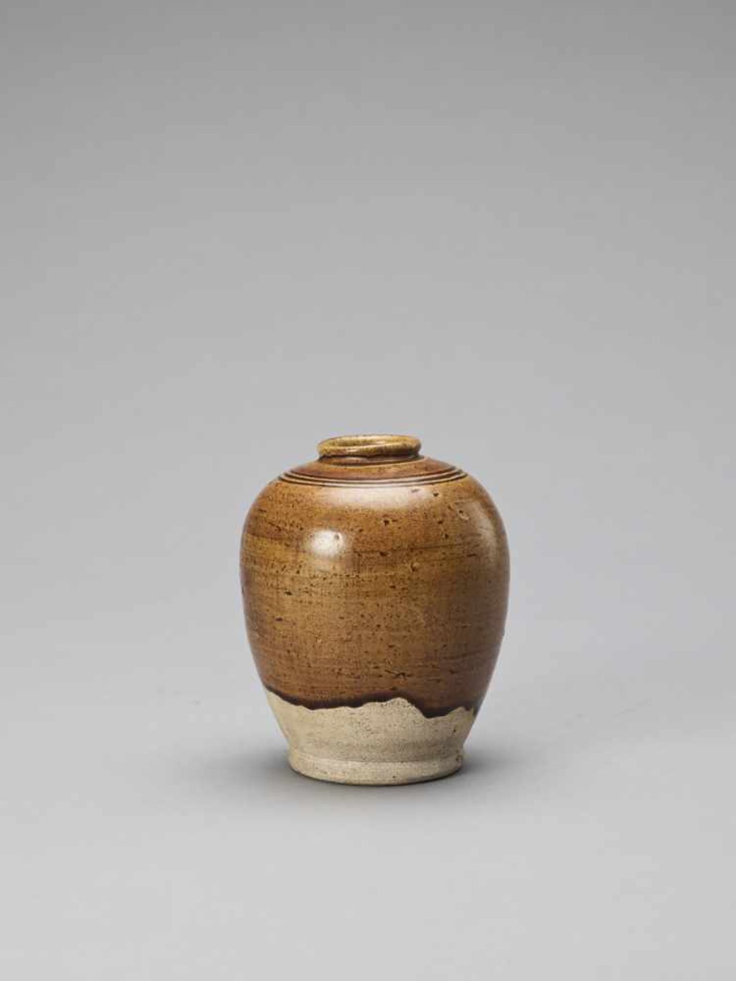 AN OCHRE BROWN-GLAZED POTTERY JAR, TANG