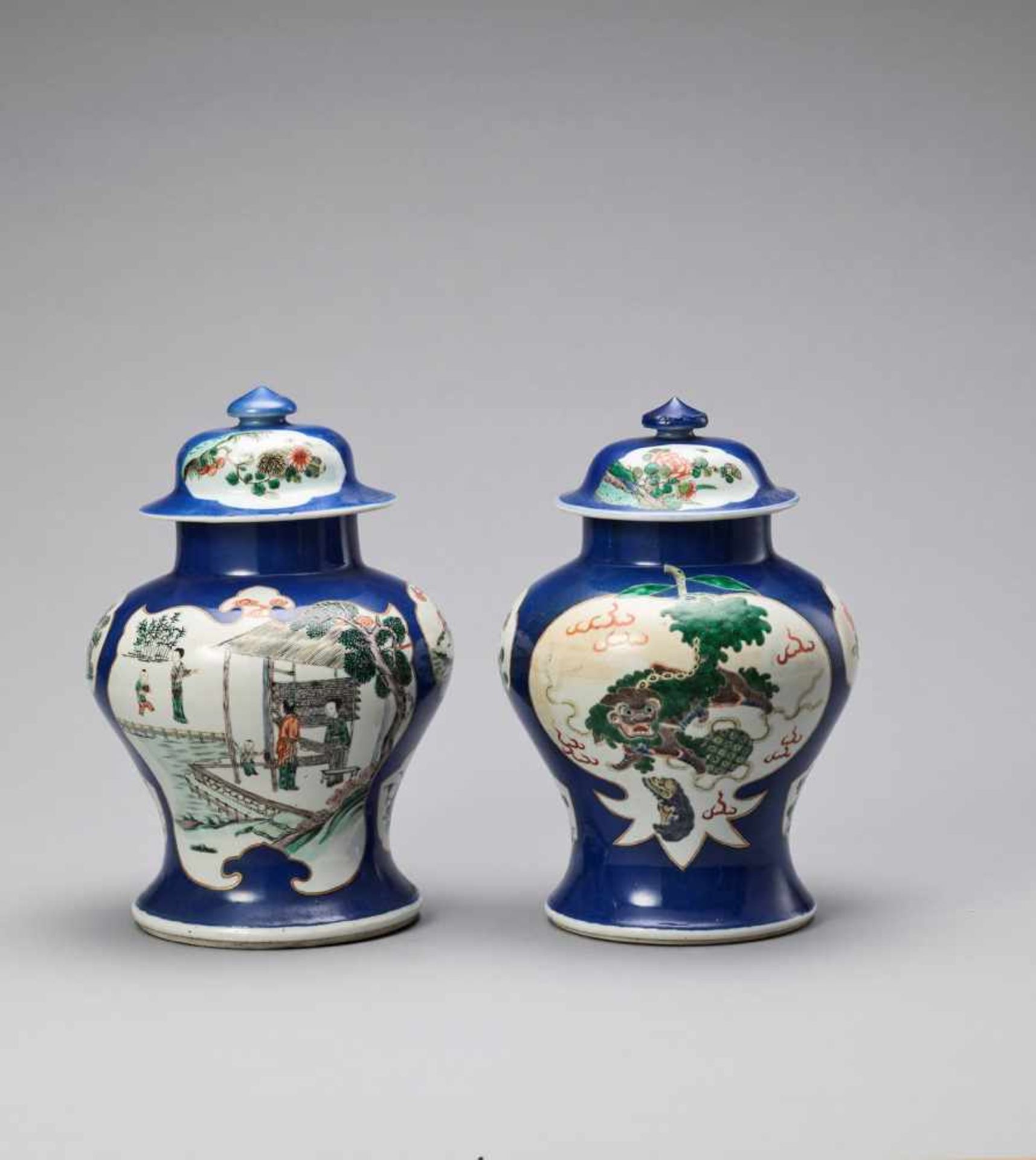 A PAIR OF POWDERBLUE GROUND FAMILLE VERTE LIDDED VASES, QING