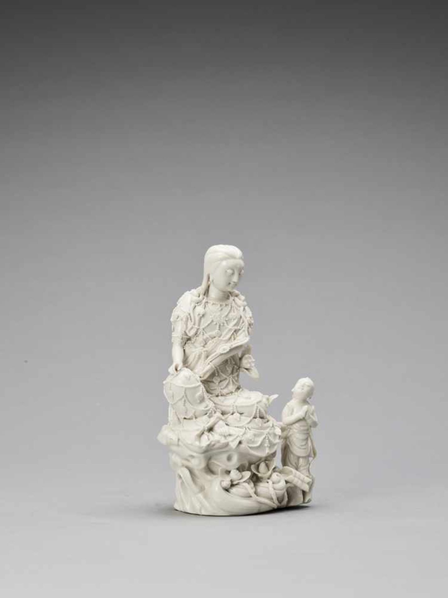 A WHITE GLAZED DEHUA PORCELAIN FIGURE OF GUANYIN AND CHILD, QING