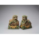 A PAIR OF RETICULATED SANCAI GLAZED POTTERY BUDDHIST LIONS, LATE MING TO EARLIER QING