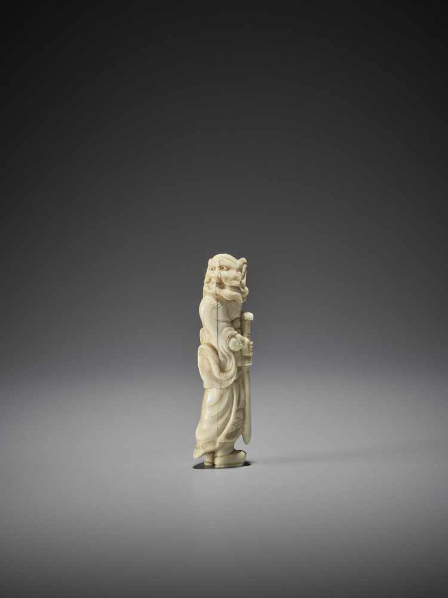 AN IVORY NETSUKE OF SHOKI